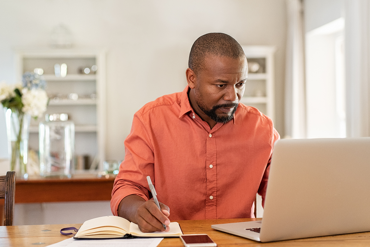 Mature man working on laptop at home