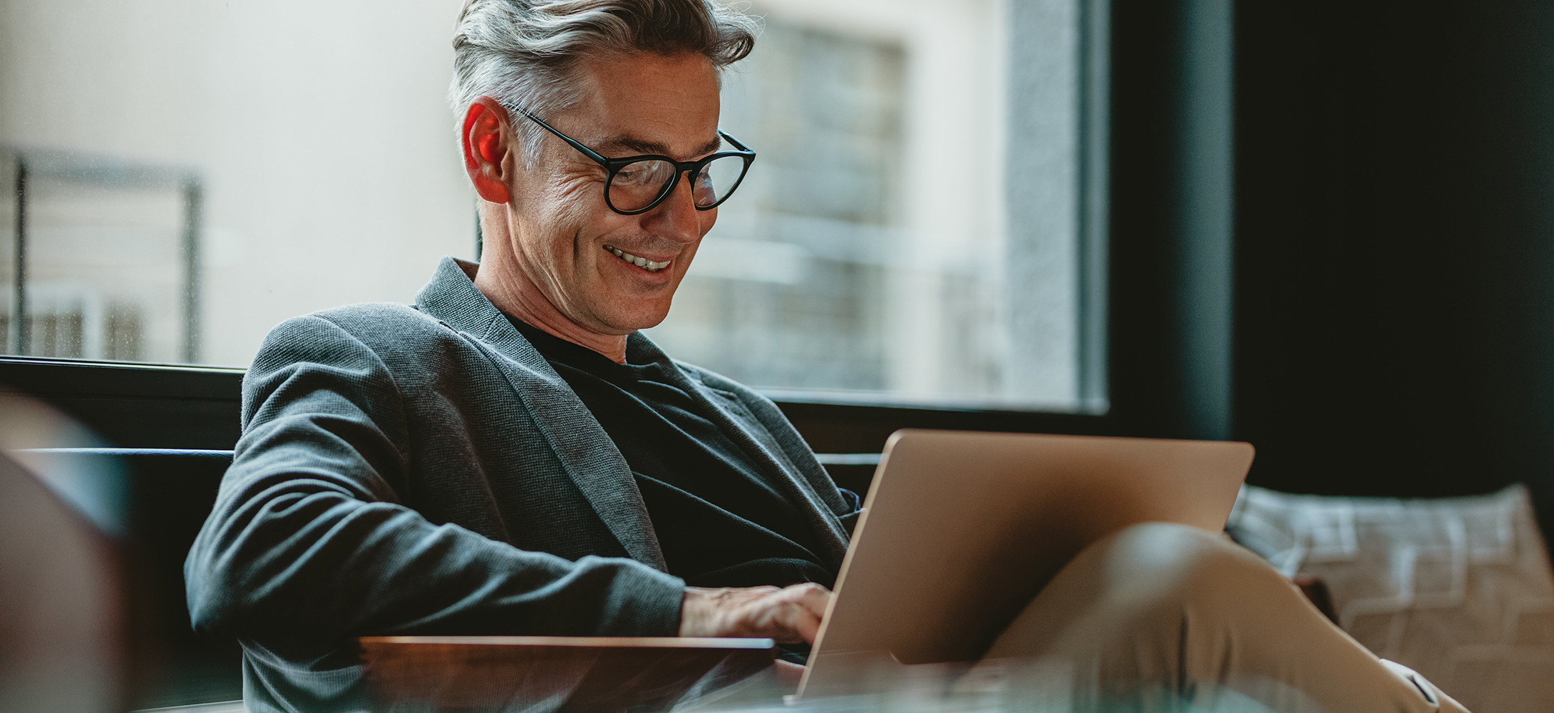 Business professional working on laptop in office lobby