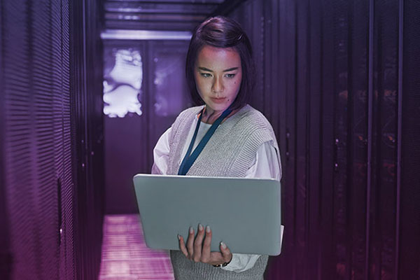 Group of people looking around computer screen