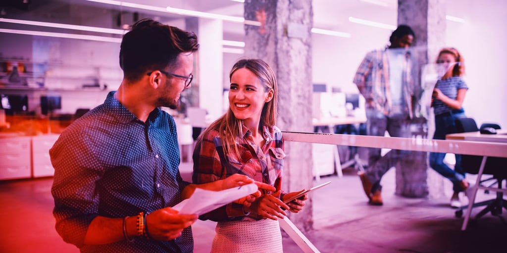 man and woman looking at each other in a business environment